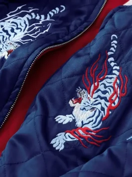 Azuki Twin Tigers Jacket in navy blue satin with quilted design, front zipper, ribbed collar and cuffs, and embroidered twin tiger artwork on the chest Patch