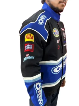 Left-side profile view of the person wearing the Dale Earnhardt Jr Oreo NASCAR Racing Jacket. The left sleeve shows the Nilla Wafers, Nutter Butter, and Fig Newtons sponsor patches, confirming it as a Vintage 90s Dale Earnhardt Jr Oreo Jacket.