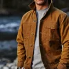 Man wearing Filson Tin Cloth Short Lined Cruiser Jacket in dark tan, durable waxed canvas workwear from America Jackets.