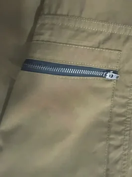 Detailed view of the front zipper closure on the Filson Upland Hunting Vest from America Jackets.
