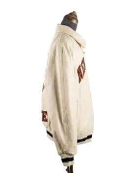 Right side profile view of the off-white Kith & Avirex New York Knicks leather jacket on a studio dress form.