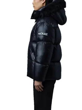 Side view of black Mackage Kent Down Puffer Jacket highlighting padded sleeves, logo patch, and luxe winter detailing.