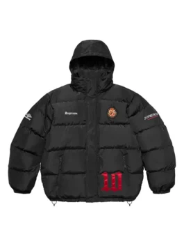 Full-frame front view of the black Supreme Umbro Down Puffer Jacket with a hood. It features 'Supreme' on the chest, a round patch emblem, an Umbro logo on the sleeve, and a large red '10' graphic.