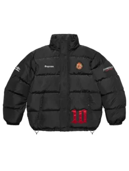 Full-frame front view of the black Supreme Umbro Down Puffer Jacket with a mock neck. It features 'Supreme' on the chest, a round patch emblem, an Umbro logo on the sleeve, and a large red '10' graphic.