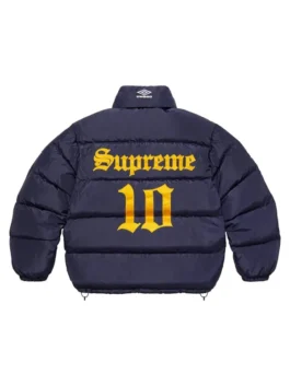Full-frame back view of the navy blue Supreme Umbro Down Puffer Jacket with a mock neck (no hood). It has a large yellow 'Supreme' and '10' graphic printed on the back.