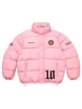 Full-frame front view of the pink Supreme Umbro Down Puffer Jacket with a mock neck (no hood). It features 'Supreme' on the chest, a patch emblem, an Umbro logo on the sleeve, and a large black '10' graphic.