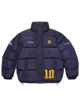 Full-frame front view of the navy blue Supreme Umbro Down Puffer Jacket with a mock neck (no hood). It features 'Supreme' on the chest, a patch emblem, an Umbro logo on the sleeve, and a large yellow '10' graphic.