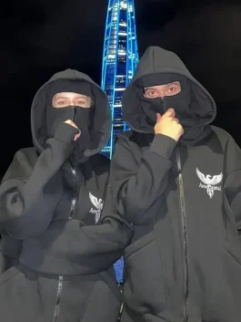 couple wearing matching balaclava style zip up hoodies, black urban street fashion hoodie