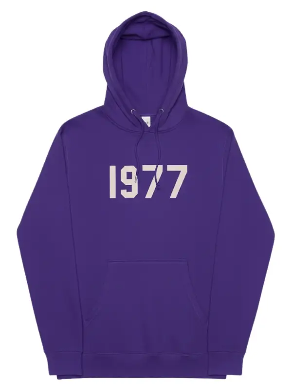 A bright purple Fear of God Essentials hoodie with the large numbers "1977" printed in a contrasting light color on the chest.