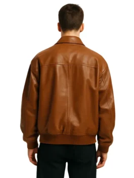 Stylish men's outerwear: oversized brown leather bomber jacket with a comfortable, relaxed cut and multiple front pockets.