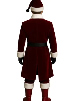 Red velvet Santa Claus coat for men (back view) featuring a knee-length overcoat style, white Vegan -fur trim on the collar and cuffs, and a black belt. The wearer is also sporting a Santa hat, black gloves, and red boots.