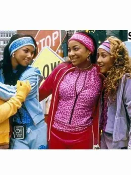 Disney’s Cheetah Girls stars in bright cheetah tracksuit styles, including red, purple, and blue velour sets with headbands and matching tops.