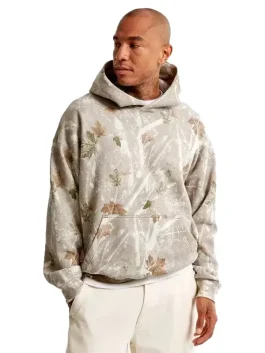 Model wearing white camo sweatshirt Abercrombie styled with casual trousers for a streetwear look.