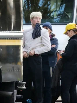 Barry Keoghan in his Crime 101 servant uniform look, wearing a fitted cream jacket with brass buttons.