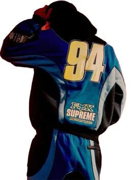 Rear view of blue and black Supreme Fox Racing Zip Up Hooded Sweatshirt with Pant displaying large 94 graphic and Fox Supreme Factory Team details.