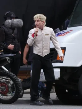 Barry Keoghan wearing the Crime 101 bellboy costume with beige jacket and dark pants from the movie set.