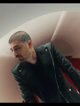 Close-up of Zayn Malik in Eyes Closed music video wearing black leather jacket with silver zipper, stylish modern biker design.