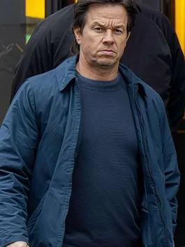 Mark Wahlberg sporting The Family Plan 2 blue jacket, walking with a serious expression