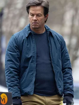Mark Wahlberg wearing a casual blue jacket from The Family Plan 2, looking confident
