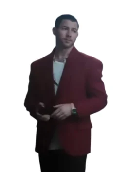 Nick Jonas wears a dark red blazer over a white t-shirt, standing and looking slightly to his right. He is wearing a dark watch on his left wrist.