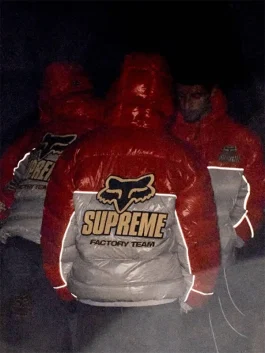 Group wearing Supreme Fox Racing shiny down puffer jackets with reflective detailing, streetwear insulated outerwear.