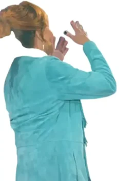 Reba McEntire on The Voice S28 stage in her blue fringe coat, a back view of the vibrant teal jacket.