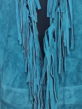 Close-up of the flowing fringe detail on Reba McEntire's turquoise fringe jacket The Voice, S28 outfit.