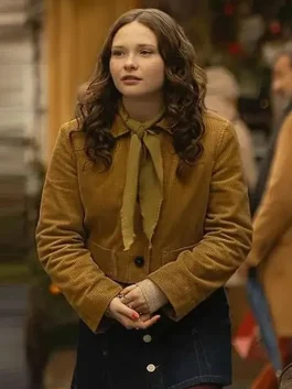 Zoe Colletti wearing a corduroy jacket with a green tie, captured while walking on the street in The Family Plan 2