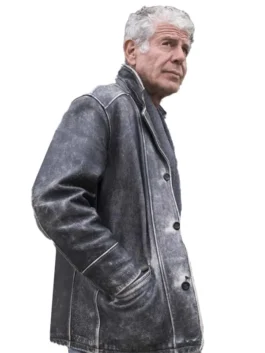 Anthony Bourdain wearing his iconic long grey Anthony Bourdain utility jacket with a knit scarf.