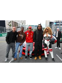Beyoncé poses with Lewis Hamilton in a Louis vuitton Las Vegas F1 racer style track suit.