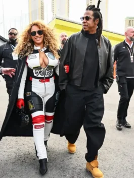 Beyoncé walks in a long coat over her Louis vuitton Las Vegas Formula 1 Grand Prix track suit.
