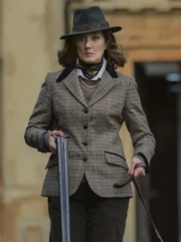Joely Richardson Plaid Blazer Sabrina in The Gentlemen 2024 wearing a classic houndstooth plaid blazer with a velvet collar and riding hat.
