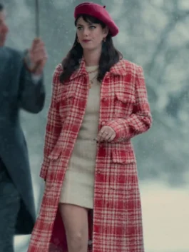 Kaya Scodelario as Susie Glass in her striking red and white plaid coat from The Gentlemen 2024 series, worn with a red beret.
