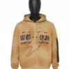 Front view of a mannequin wearing the tan, distressed full-zip hoodie. The front features collaboration graphics including small black Nike swooshes, large black text in both English ("HOUSTON" and "ISE MIE") and Japanese characters, indicating a journey or connection between the two locations.