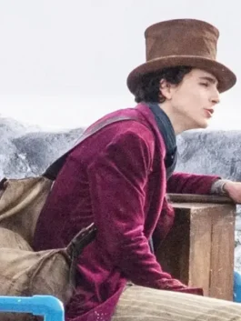 Close-up of Timothée Chalamet in the Wonka 2023 Willy Wonka Coat. This rich maroon velvet coat is the character's signature look.