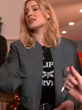 Blonde woman wearing a charcoal gray zip-up bomber jacket with a stand collar and front flap pockets indoors.