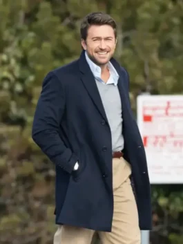 Brandon Sklenar blue coat The Housemaid 2025 movie scene. Andrew Winchester wearing a navy blue single-breasted wool overcoat with a popped collar.