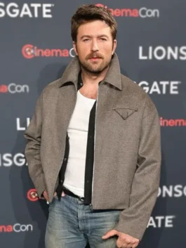 Actor Brandon Sklenar Andrew Winchester grey jacket in a medium close-up. The Housemaid Brandon Sklenar gray jacket shows a high-collar design.