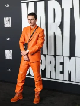 Timothée Chalamet modeling his stylish orange suit by Chrome Hearts on the Marty Supreme premiere red carpet.