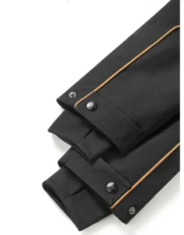 Close-up of the cuffs and sleeves of the black Destiny 2 The Final Shape Jacket featuring gold trim and snap buttons. Salvation's Edge Jacket.
