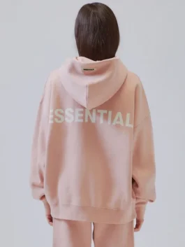 Rear view of the Fear of God Essentials Pacsun Hoodie Peach, showcasing the bold ESSENTIAL graphic. A popular unisex pullover.