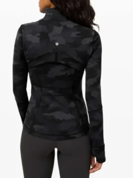 Rear view of a camo lululemon jacket showing the reflective logo, back ventilation flap, and slimming seams of the lulu define jacket camo.