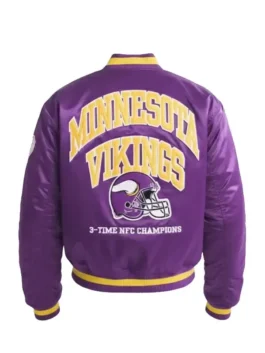 Back of a purple Minnesota Vikings satin bomber jacket with "MINNESOTA VIKINGS," a large helmet logo, and "3-TIME NFC CHAMPIONS."