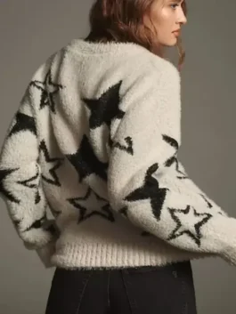 Back view of a white fuzzy star sweater with black stars on the back and sleeves.