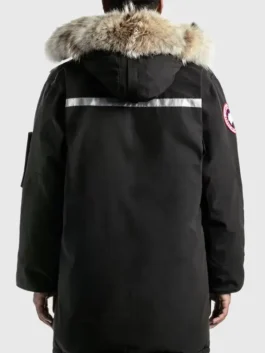 Back view of a men’s black parka jacket with a fur-trim hood and reflective strip across the upper back.