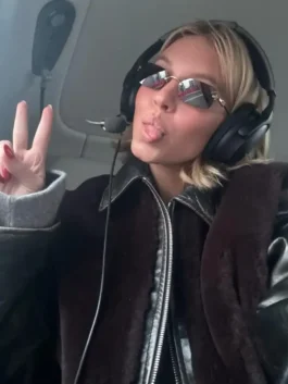 Close-up of Sydney Sweeney wearing a black leather blouson jacket with shearling and sunglasses; a premium leather jacket with shearling for women.