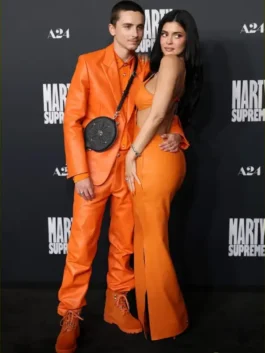 Timothée Chalamet and Kylie Jenner pose in their bold orange Chrome Hearts style at the Marty Supreme premiere.