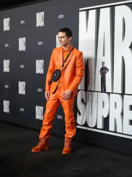 Timothée Chalamet on the Marty Supreme premiere red carpet wearing his eye-catching orange Chrome Hearts suit.