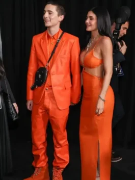 Timothée Chalamet and Kylie Jenner in matching orange Chrome Hearts attire at the Marty Supreme premiere.