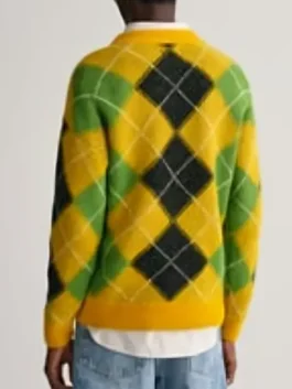 Back view of a yellow fuzzy sweater with green and black argyle pattern.